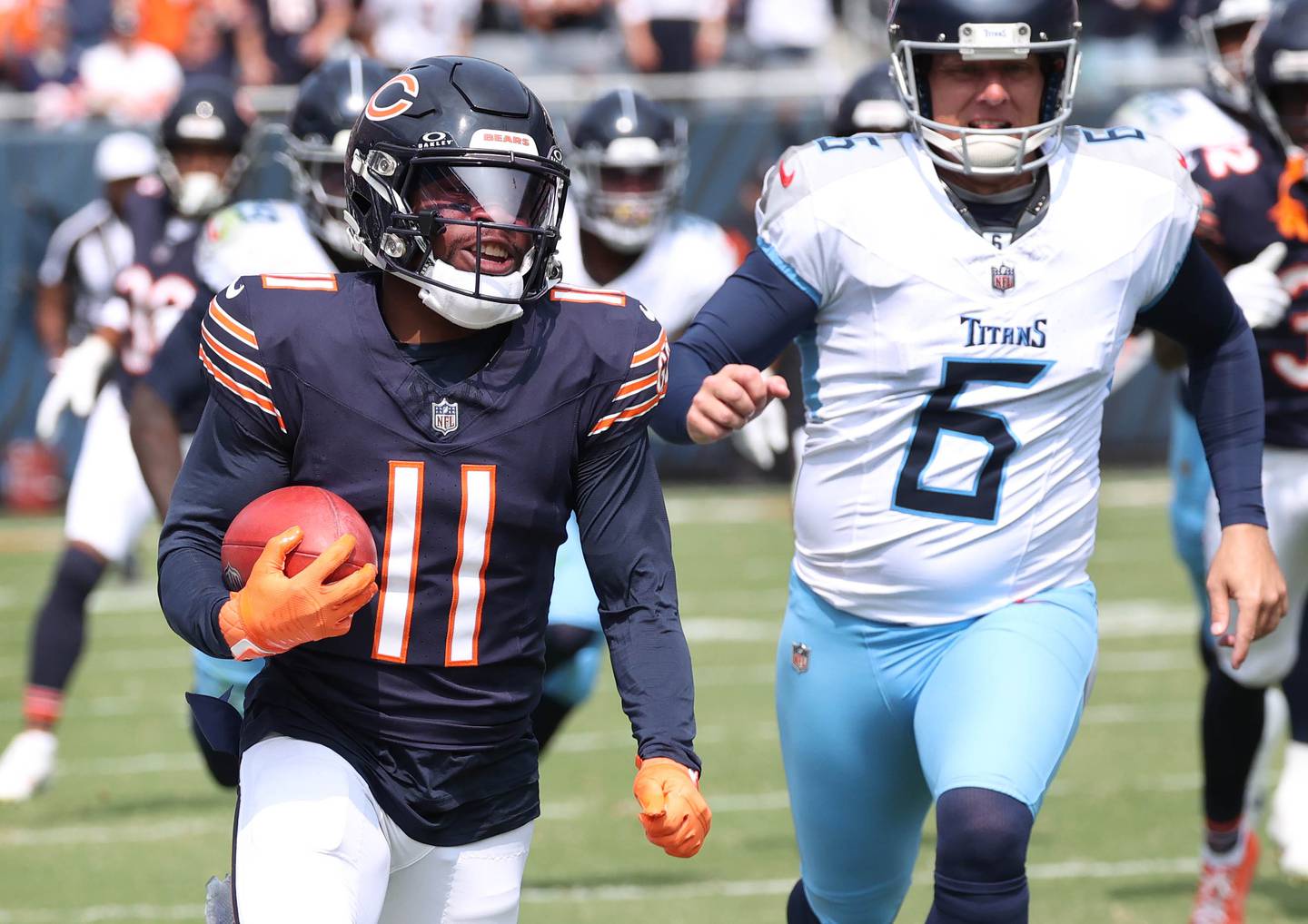 Chicago Bear kick returner DeAndre Carter picks up big yardage on a kickoff as Tennessee Titans place kicker Nick Folk pursues him during their game Sunday, Sept. 8, 2024, at Soldier Field in Chicago.