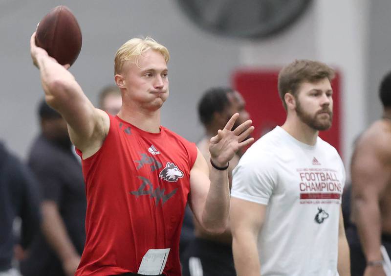 Former Northern Illinois quarterback Rocky Lombardi throws a pass as former NIU running back Clint Ratkovich looks on Thursday, March 7, 2024, during pro day in the Chessick Practice Center at NIU. Ratkovich was helping out as former NIU players got a chance to show their stuff in front of NFL scouts who attended Thursday.