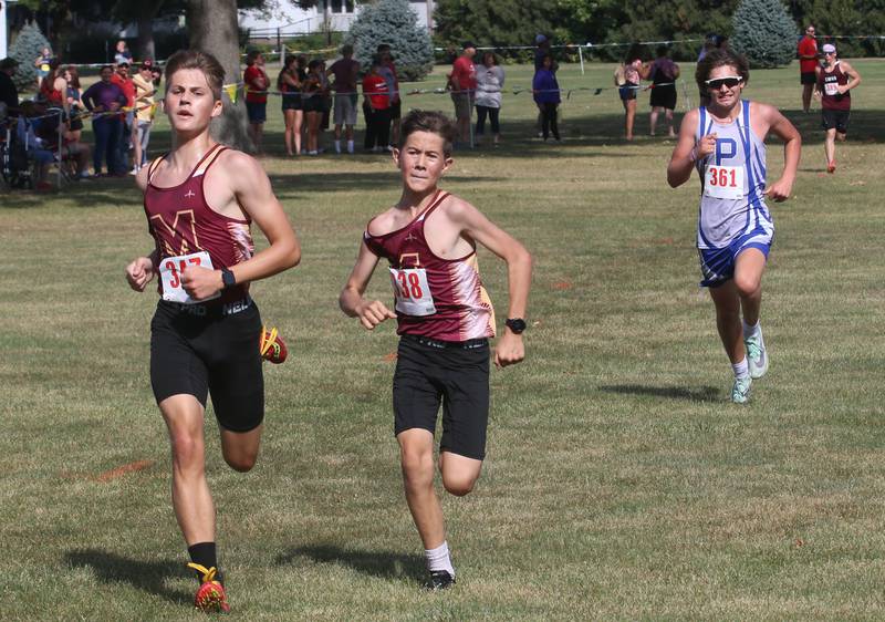 Morris's Cameron Raymer, and teammate Joseph Emmerich and Princeton's Dawson Lambert all run in the Gary Coates Cross Country Invitational on Saturday, Sept. 14, 2024 Zearing Park in Princeton.