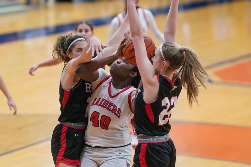 Bolingbrook's Jasmine Jones (40) shoots the ball in the paint against Benet’s Shannon Earley (25) and Bridget Rifenburg (22) during a Oswego semifinal sectional 4A basketball game at Oswego High School on Tuesday, Feb 20, 2024.