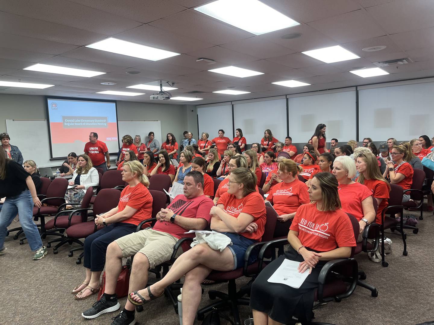 About 100 union members attended a District 47 board meeting in May 2024, many wearing red t-shirts to display solidarity.