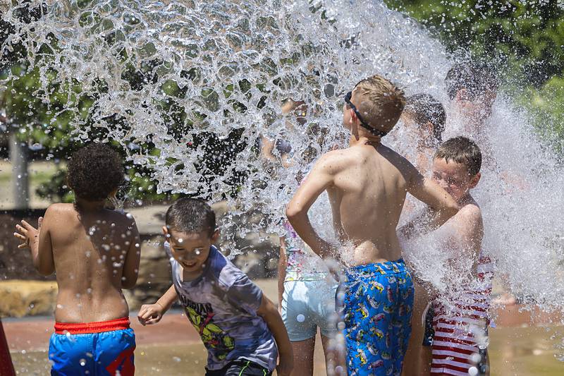 A deluge of water dumps from a bucket Wednesday, June 12, 2024 at the Dixon Park District splash pad.