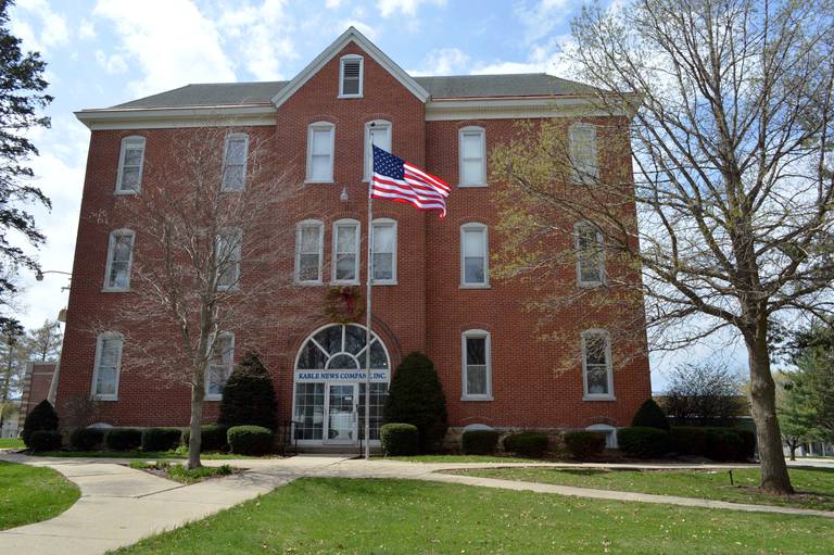 The American flag flies in front of the former Kable News Company building which also once was Mount Morris College's College Hall, on April 20, 2023. John Russell, of rural Mt. Morris, closed on his purchase of the historic building, located on the Mt. Morris campus, on March 1; he plans to restore and modify it into multi-use space that benefits the community.