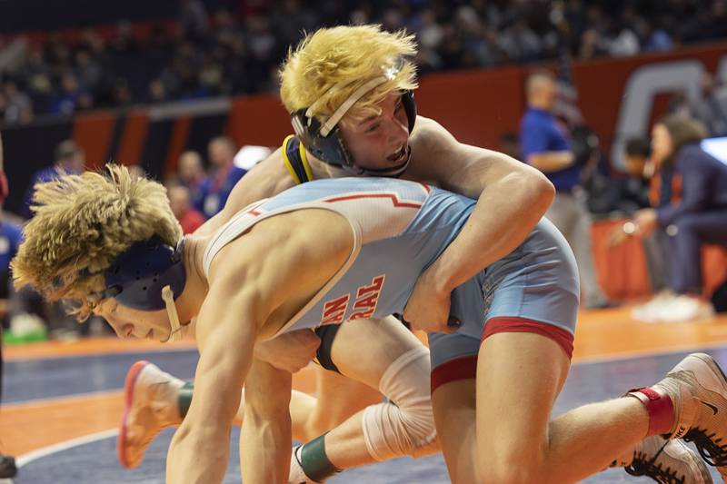 Marian’s Central’s Brayden Teunissen (left) and Carlye’s Tyson Waughtel spar in the 1A 120 pound championship match Saturday, Feb. 17, 2024 at the IHSA state wrestling finals at the State Farm Center in Champaign.