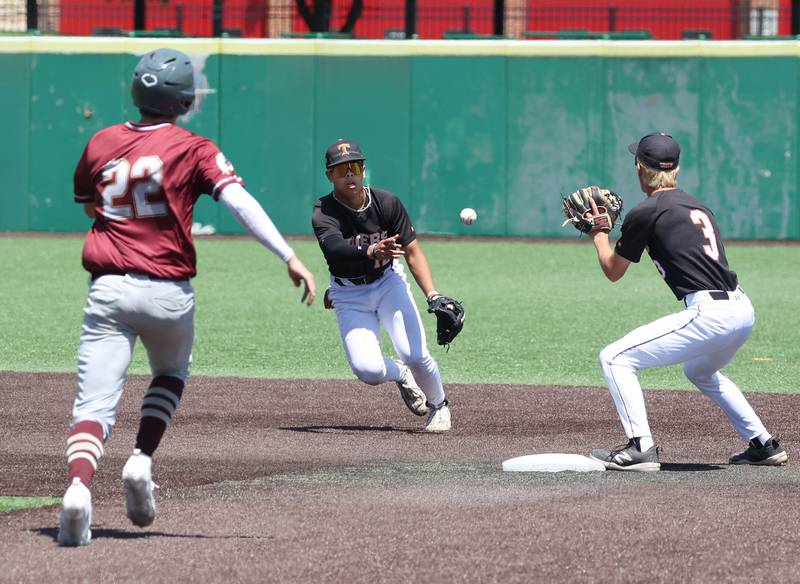 Crystal Lake Central's Jaden Obaldo flips the ball to teammate James Dreher for a force out as Morris' Brett Bounds tries to break up a double play during their Class 3A state semifinal game Friday, June 7, 2024, at Duly Health and Care Field in Joliet.