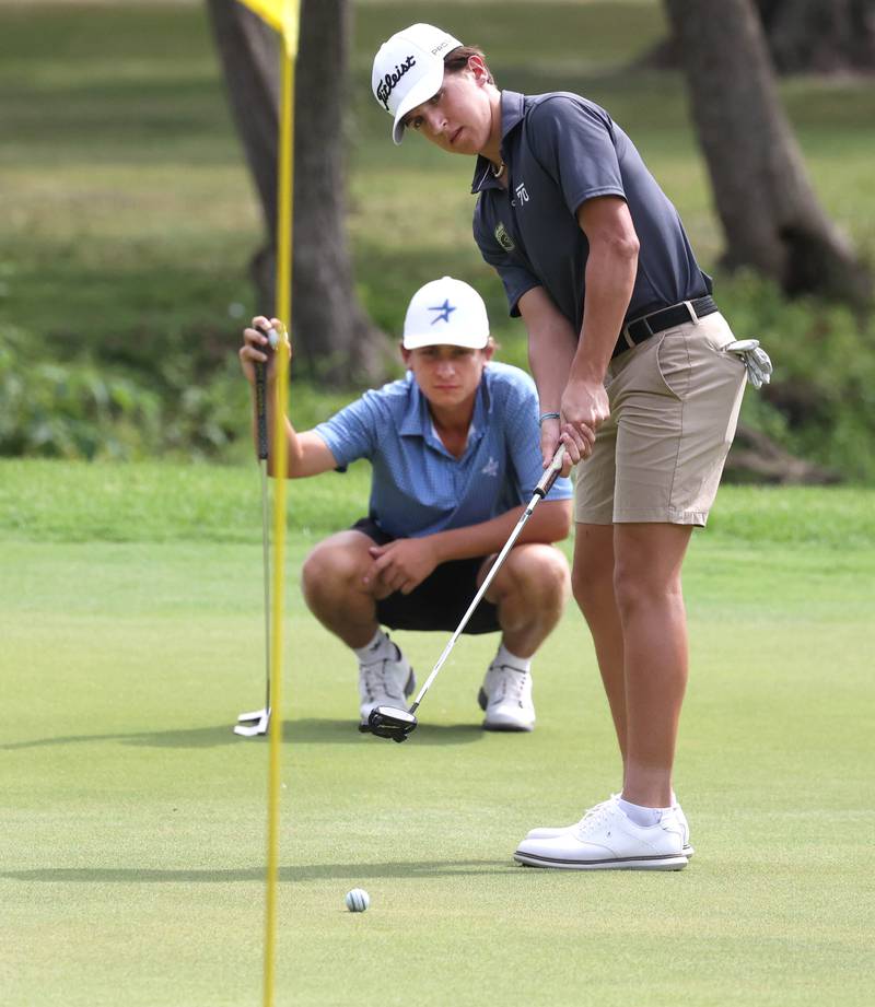 Sycamore’s Andrew Swedberg putts as St. Charles North’s Jack Van Laningham looks on Monday, Sept. 16, 2024, during the Mark Rolfing Cup at the Kishwaukee Country Club in DeKalb.