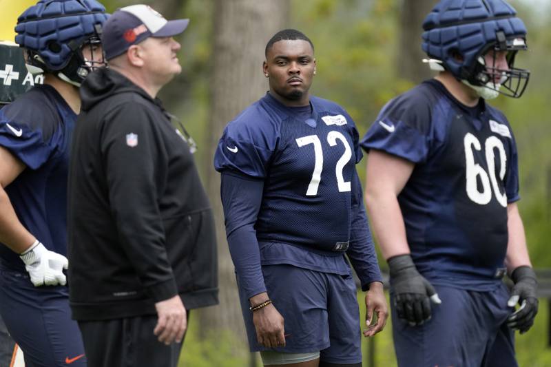 Chicago Bears offensive line Kiran Amegadjie (72) watches players during the NFL football team's rookie camp at Halas Hall in Lake Forest, Ill., Friday, May 10, 2024. (AP Photo/Nam Y. Huh)