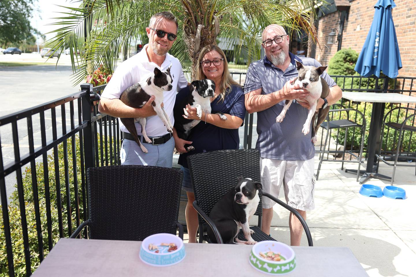 Brent Stary and his wife Tracy, owner of McBride’s on 52, along with General Manager Sean Mahoney poses for a photo with their boston terriers on Wednesday, August 21, 2024 in Joliet.