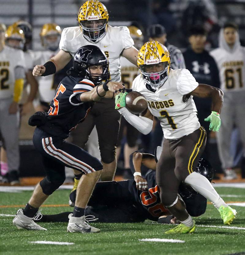 Jacobs' Prince Barnes tries to catch the football as he is hit by McHenry's Rogelio Rios during a Fox Valley Conference football game on Friday, Oct. 18, 2024, at McKracken Field in McHenry.