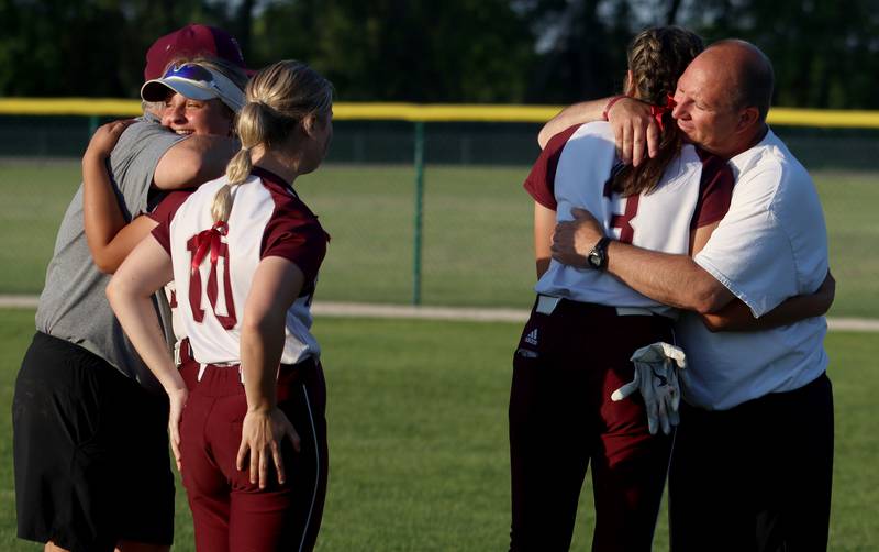 Marengo coaches Rob Jasinski and Dwain Nance share e moment with senior players Emily White, Marissa Young and Lilly Kunzer after a loss to North Boone in IHSA Softball Class 2A Regional Championship action at Marengo Friday.