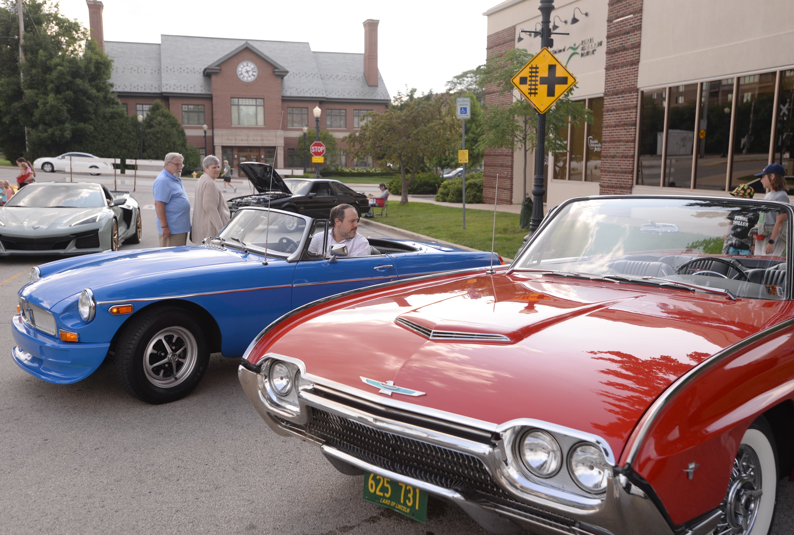 Jamison Rediehs of Hinsdale pulls his 1977 MGB into the Downers Grove Car show Friday July 19, 2024.