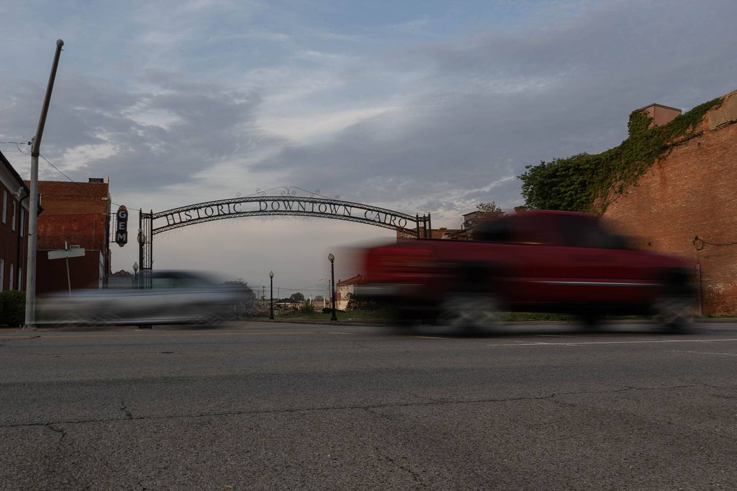 Cars pass by the Historic Downtown Cairo sign on 8th Street on April 26, 2024, in Cairo, Illinois. The street was once home to several businesses such as Cairo Chamber of Commerce, the Elks Club and Gem Theater which now all sit abandoned and empty.