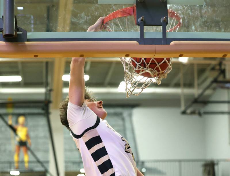 Sycamore's Ben Larry breaks ahead of the Sandwich defense for a dunk during their game Friday, Nov. 24, 2023, in the Leland G. Strombom Holiday Tournament at Sycamore High School.