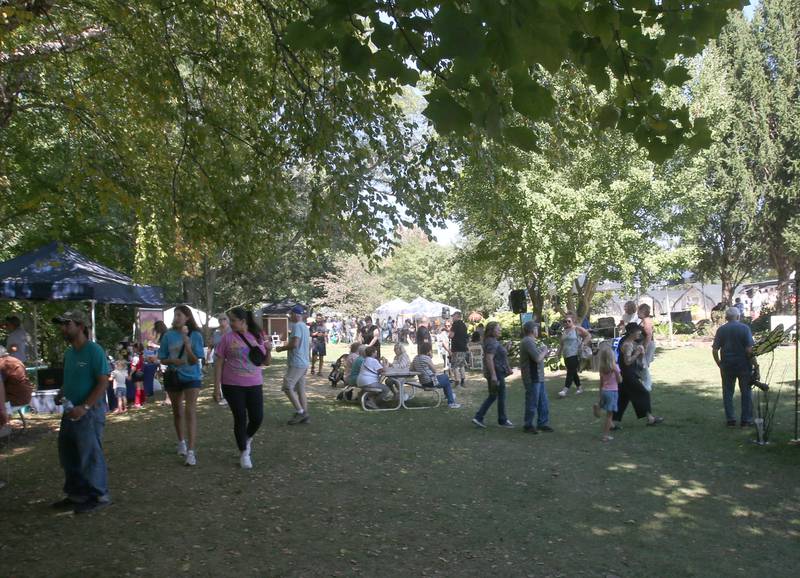 People walk around the Artisan Market on Saturday, Sept. 14, 2024 at Hornbakers in Princeton.