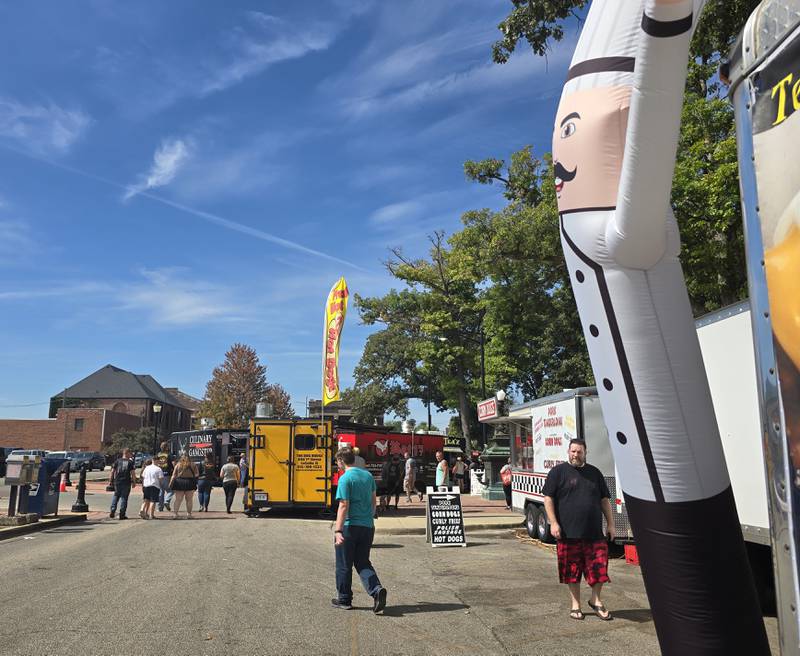 Fall Food Truck Festival patrons are greeted by an inflatable tube man Saturday, Sept. 14, 2024, at City Park in Streator.