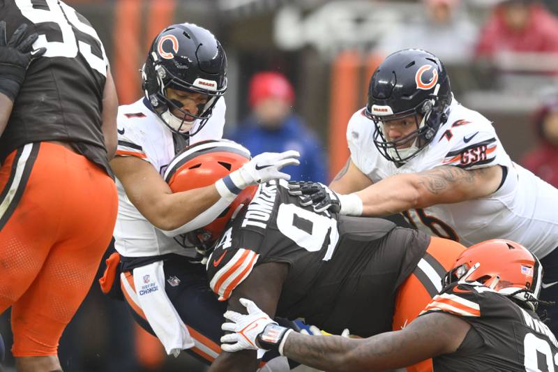 Cleveland Browns defensive tackle Dalvin Tomlinson sacks Chicago Bears quarterback Justin Fields in the first half in Cleveland, Sunday, Dec. 17, 2023.
