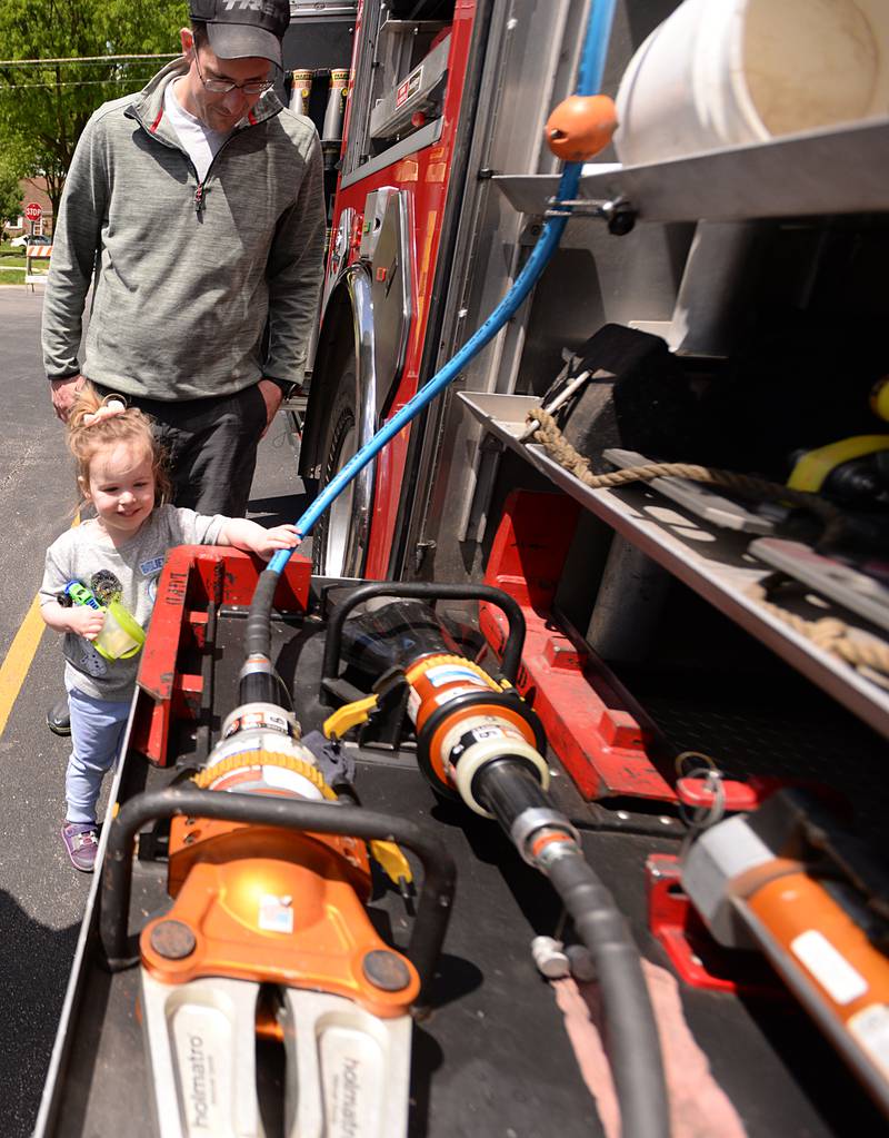 Brad and Ada Yelton take a closer look at the jaws of life during the La Grange Park District's Touch A Truck event held at Sedgwick Park Saturday May 11, 2024.