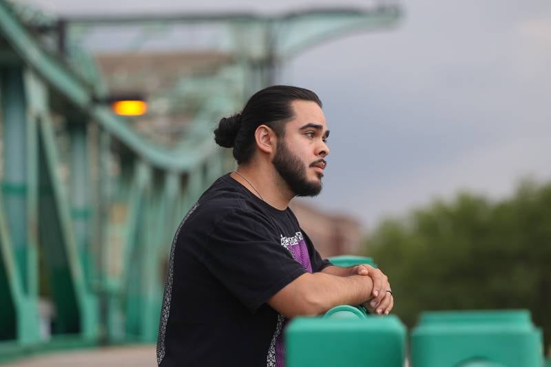 Uxmar Torres stands on the Jefferson Street Bridge in downtown Joliet on Tuesday June 4, 2024. Uxmar who has a degree in creative writing has showed his poetry and spoken word in dozens of cities across the United States.