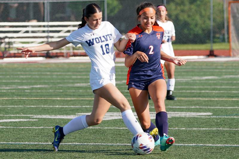 Oswego East's Ashley Gumm (18) challenges Oswego’s Grace Braun (2) for the ball during a Class 3A Lockport Regional semifinal soccer match at Lockport High School in Lockport on Wednesday, May 15, 2024.