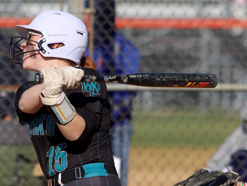 Woodstock North’s Mackenzie Schnulle homers in varsity softball at Crystal Lake Central Friday.