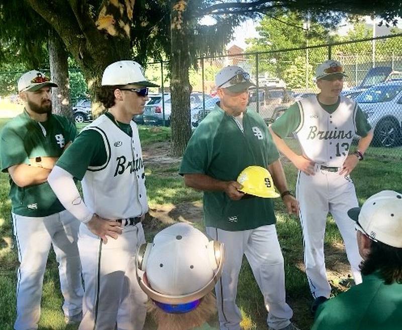St. Bede coach Bill Booker presents the Bruins' Player of the Game helmet to Gus Burr (left) and Alex Ankiewicz after Wednesday's 7-0 sectional win over Heyworth. Burr had a key three-run triple to break the game open in the fourth inning. Ankiewicz.spun a three-hit, shutout with 12 strikeouts to pitch the Bruins into Saturday's championship game vs. Annawan/Wethersfield at 11 a.m.