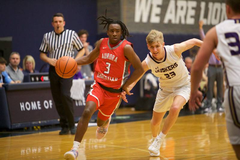 Aurora Christian's Marshawn Cocroft drives the lane against Serena's Tanner Faivre at the Class 1A Boy's Basketball  Super Sectional on Friday , March 1, 2024 at Harvest Christian Academy  in Elgin.