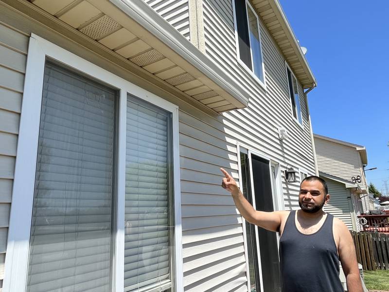 Jose Ramirez points to the a section of a window at his Romeoville residence on Friday, May 26, 2023, that was damaged by a bullet. A shooting occurred on Thursday, May 26, 2023, near the area as officers were trying to apprehend a suspect in a stolen motor vehicle incident.