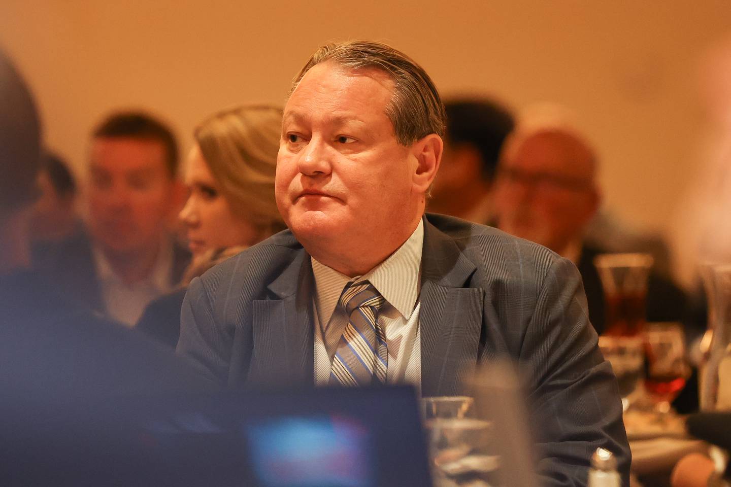 Joliet City Manager James Capparelli listens to Joliet Mayor Bob O’Dekirk give his annual State of the City address at Harrah’s. Wednesday, Mar. 9, 2022, in Joliet.