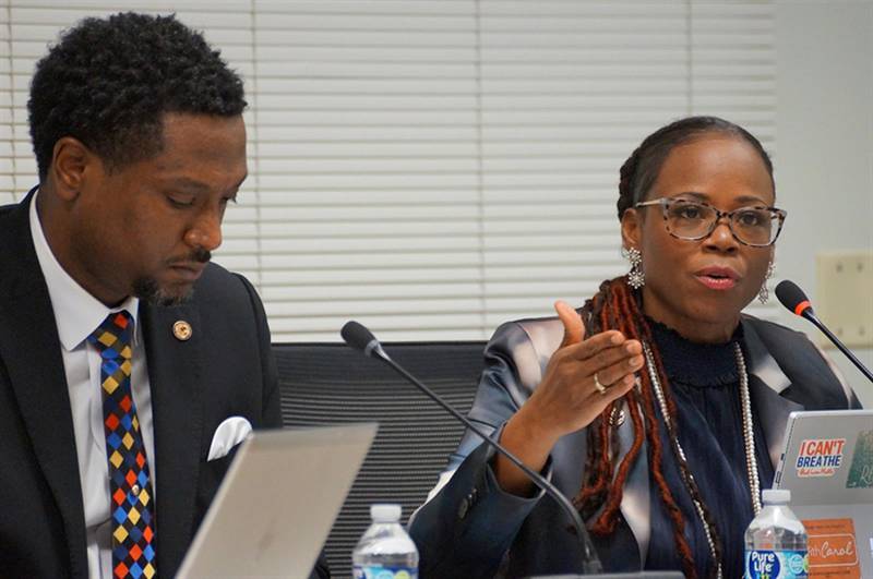 Democratic state Reps. Maurice West, of Rockford, and Carol Ammons, of Urbana, discuss Ammons’ proposal to expand voting by mail in Illinois during a meeting Wednesday of the House Ethics and Elections Committee.