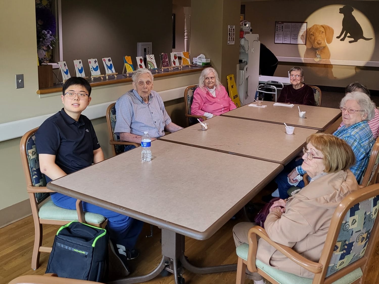 Leonardo Chung sitting with residents at Pleasant View Senior Community in Ottawa.