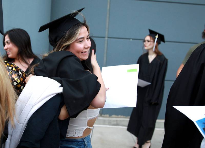 Kaneland High School graduate Amya Estrada hugs her friends and family following the school’s 2024 Commencement Ceremony at Northern Illinois University in DeKalb on Sunday, May 19, 2024.