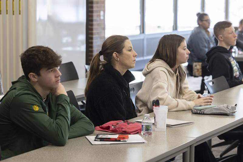 Kellen Haenitsch (left) with mom, Andrea, and sister, Kennedy, listens as SVCC student ambassadors talk Monday, Feb. 19, 2024, about the advantages of attending Sauk Valley Community College.