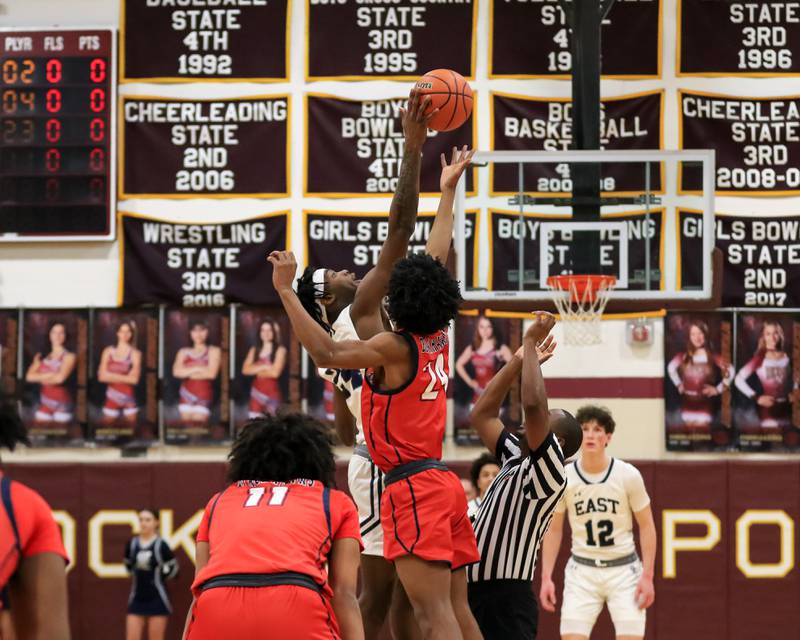 Oswego East's Mekhi Lowery (24) with the tipoff against West Aurora's Terrence Smith (24) during Class 4A Lockport Regional final game between West Aurora at Oswego East.  Feb 24, 2023.