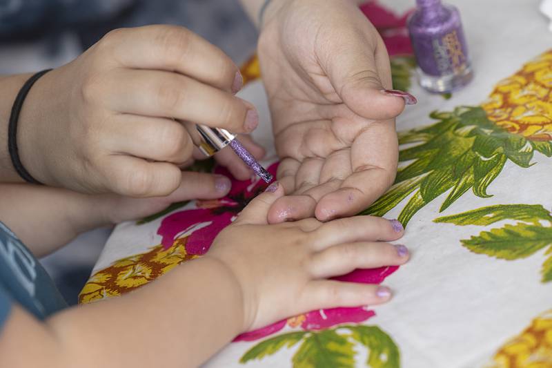 Stella Nagy, 2, gets some sparkly new fingernails Saturday, June 8, 2024 at the Summer Block Party in Dixon.