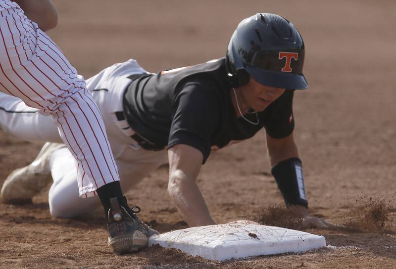 Crystal Lake Central's John Dobbeck dives back to first base during a Class 3A Grayslake Central sectional championship baseball game against Deerfield on Friday, May 31, 2024, at the Grayslake Central High School.