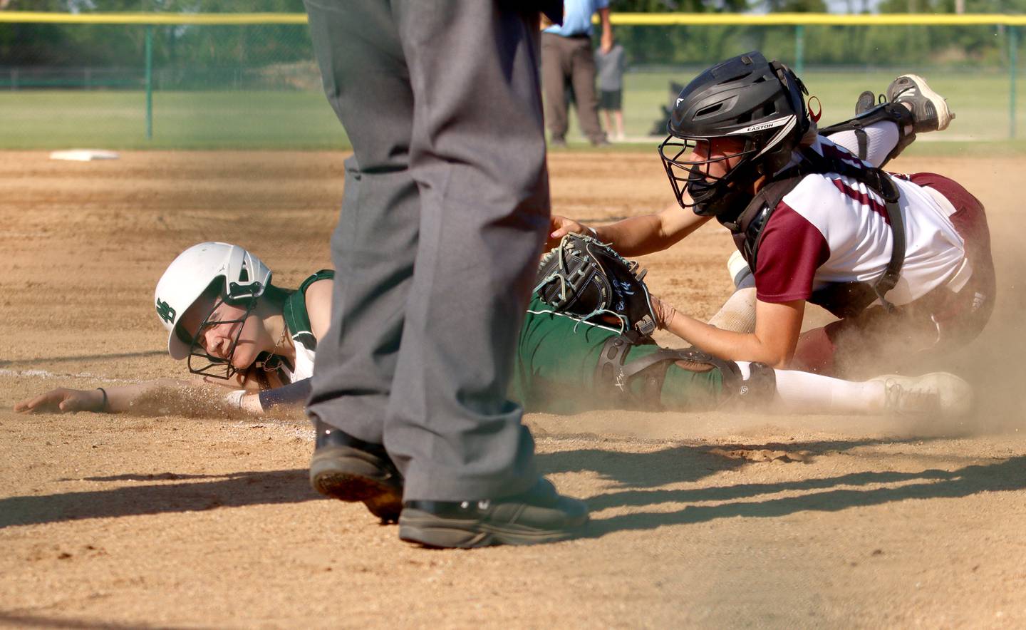 Marengo’s Kylee Jensen, right, tags out North Boone’s Sydney Goodman in IHSA Softball Class 2A Regional Championship action at Marengo Friday.