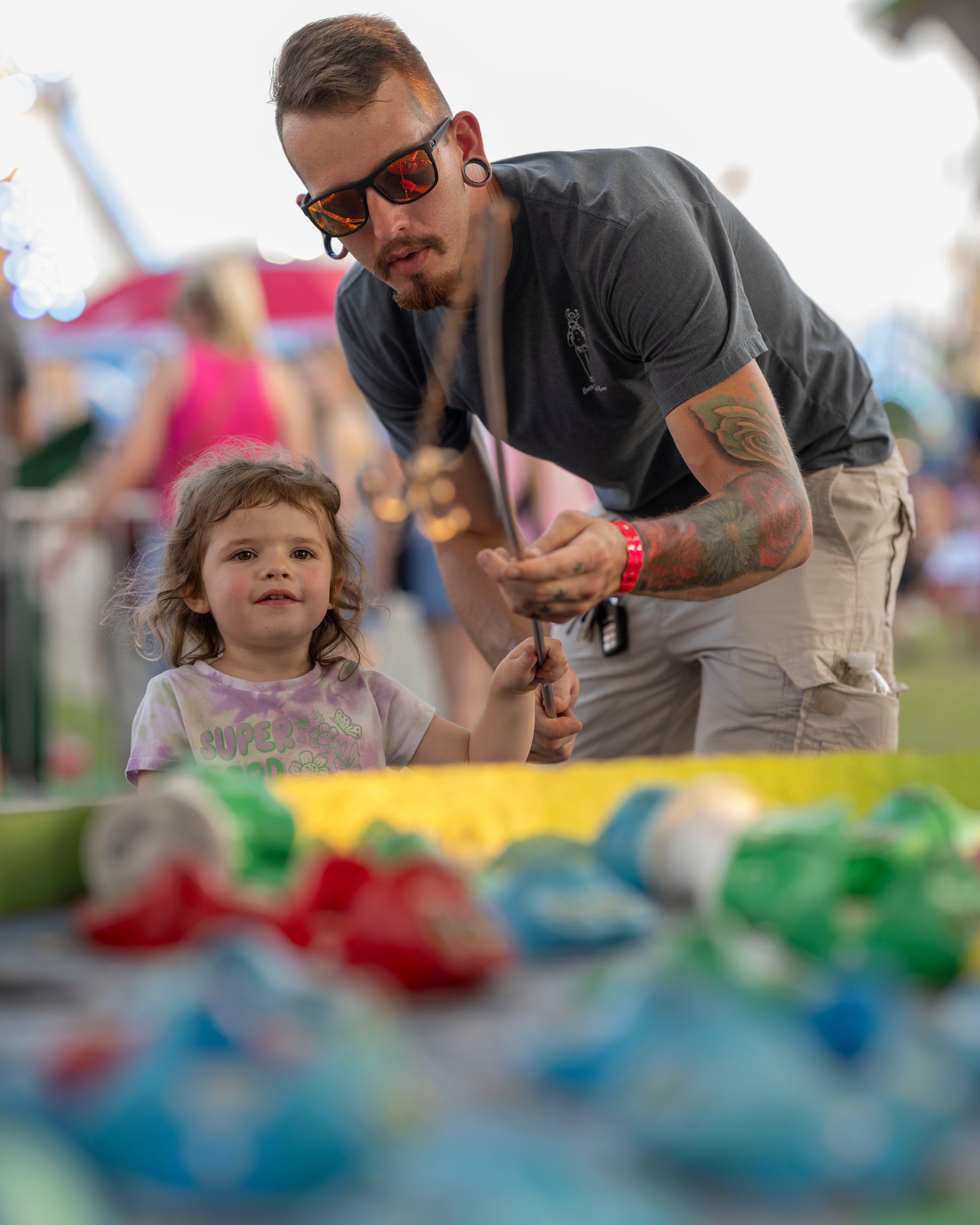 Hunter Perhach and his daughter Willow play the fishing game at Streatorfest on August 2, 2024.