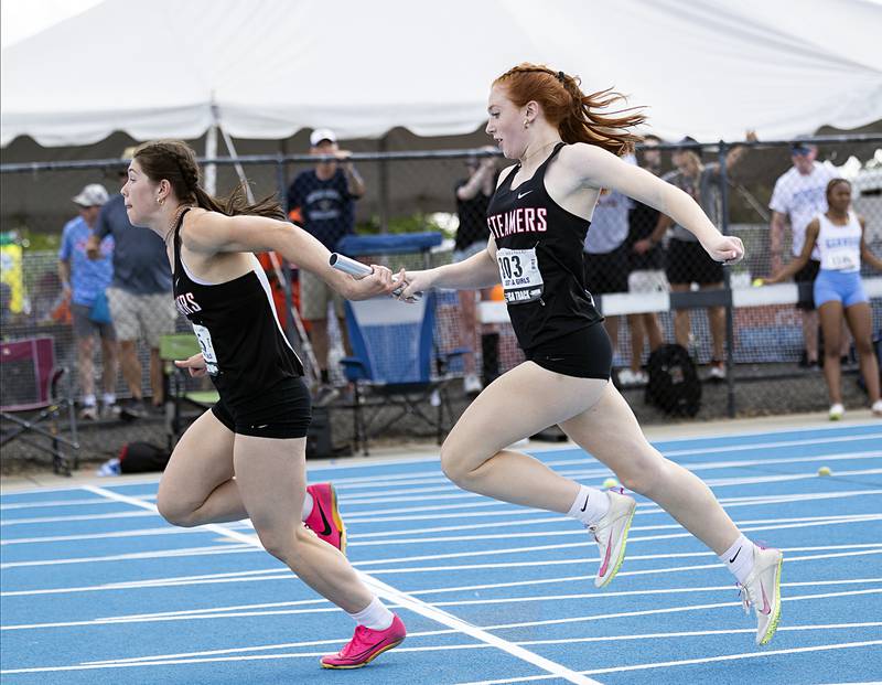 Fulton’s Brooklyn Thoms takes the baton from Paige Cramer in the 1A 4x100 Saturday, May 18, 2024 at the IHSA girls state track meet in Charleston.