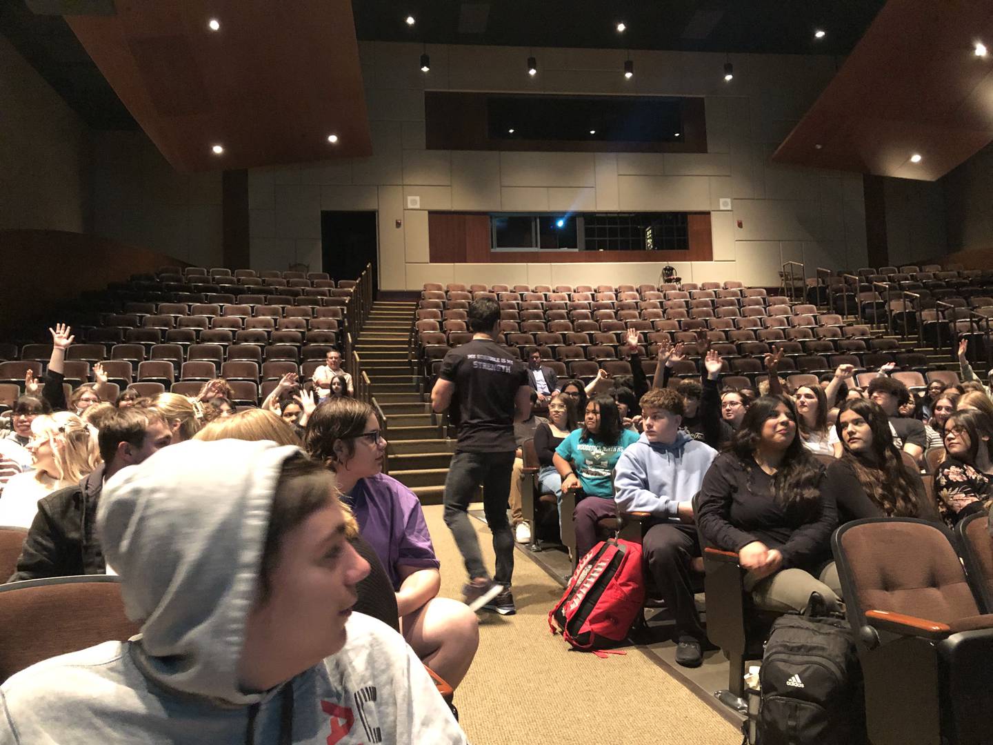 Jordan Toma, a New Jersey-based motivational speaker, hands out giveaway items to Woodstock North High School students April 9, 2024.
