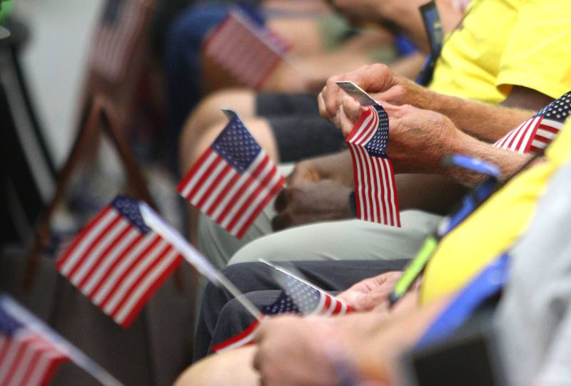 Veterans hold flags as McHenry Community High School hosted a celebration Sunday for veterans returning from an Honor Flight trip to Washington D.C. The Honor Flight trip was coordinated by the Veterans Network Committee of Northern Illinois.