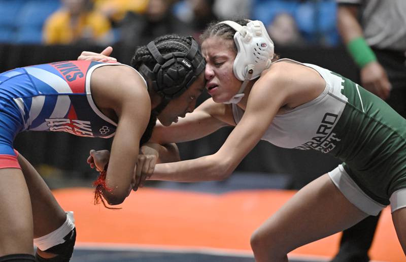 Glenbard West’s Alycia Perez bumps her face against West Aurora’s Kameyah Young in the 100-pound bout at the girls wrestling state finals at Grossinger Motor Arena in Bloomington on Saturday, Feb. 24, 2024.