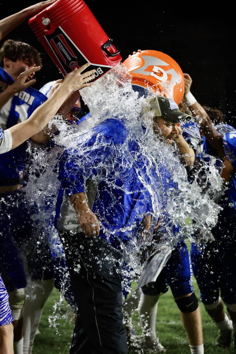 Princeton players douse coach Ryan Pearson after he recorded his 100th career win with Friday's 57-20 win over Mercer County at Bryant Field.