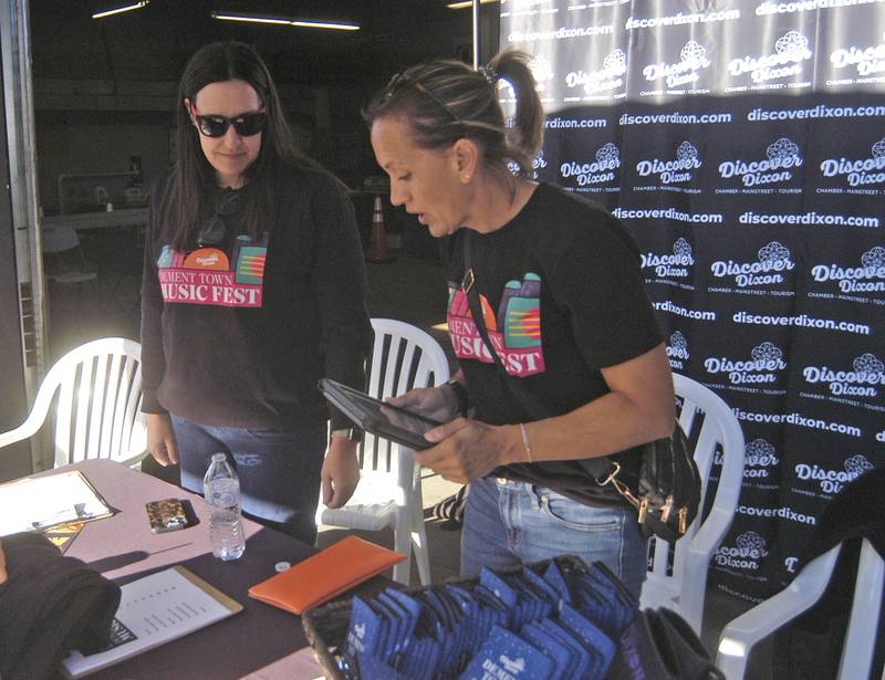 Amanda Wike and  Amber Schmidt go over prices at the  Discover Dixon booth at the Dement Town Music Fest. The fest, presented by Discover Dixon was held on Saturday, Sept. 7, 2024