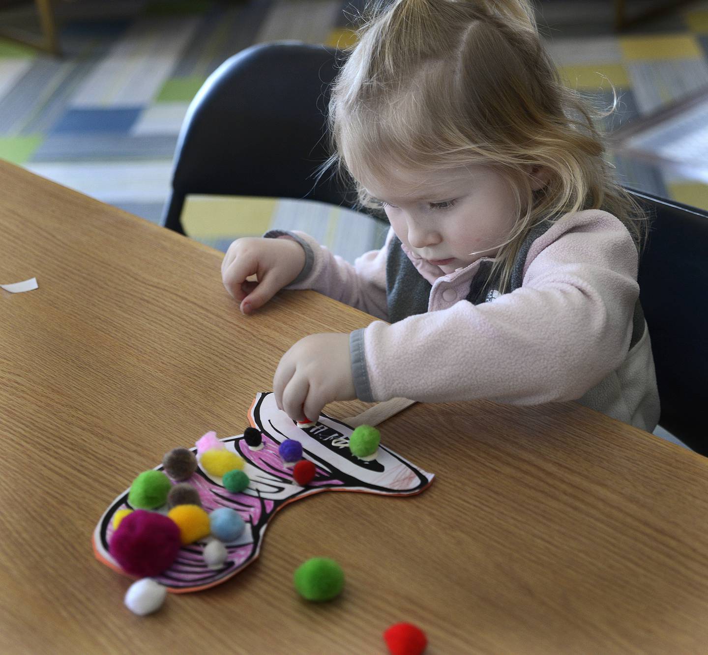 Everly Nagle puts the finishing touches on her Cat In The Hat themed creation Saturday, March 2, 2024, at the Streator Public Library. A Seussical Celebration was held to commemorate the birthday of Dr Seuss.