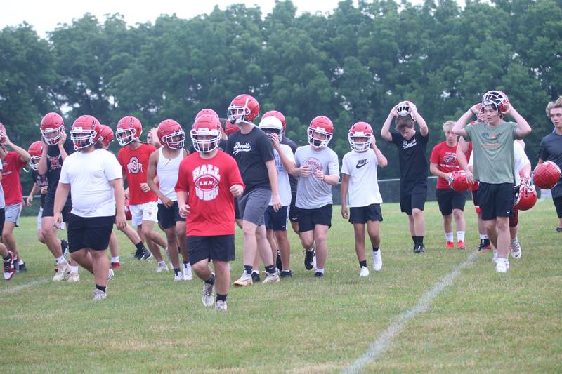 Members of the Hall football team take a break while practicing on Tuesday, July 9, 2024 at Hall High School.