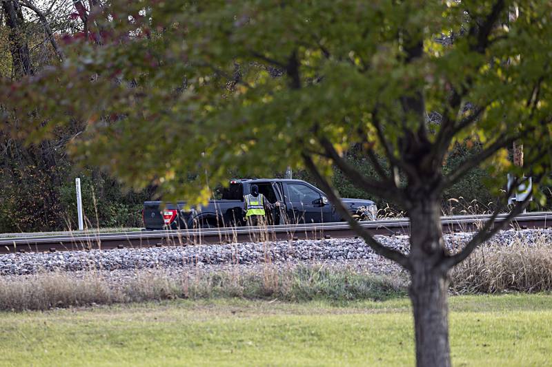 Railroad officials work at a crossing Wednesday, Nov. 1, 2023 off of Railroad Ave and Wadsworth Way near Nelson.