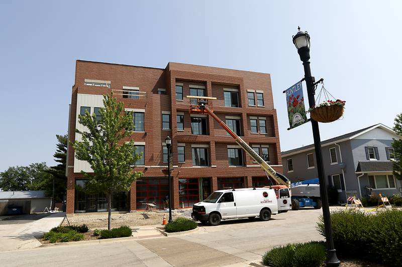 Work continues Wednesday, June 7, 2023, to finish the new building at 11808 Coral St. in Huntley. The building is mixed use with retail and restaurant space on the first floor and residential space on the upper floors.
