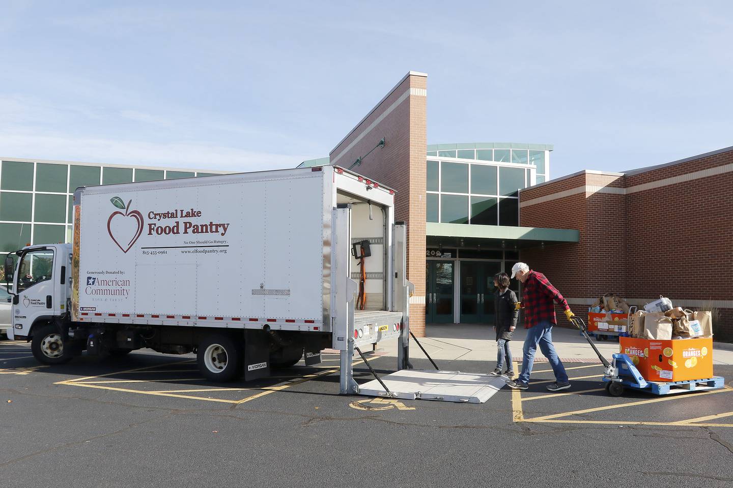 Crystal Lake Food Pantry food rescue manager Tanya Hill, left, and food rescue volunteer Paul Georgy load their truck with donations during a Community Harvest food drive on Friday, Nov. 19, 2021, at Northwestern Medicine Health and Fitness Center in Crystal Lake. About 40 sponsoring sites helped contribute to the annual food collection and donation campaign for the Crystal Lake Food Pantry.