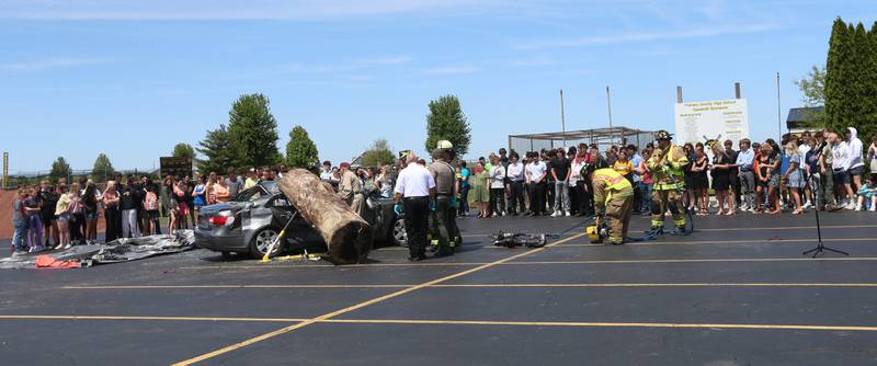 Putnam County High School students watch fire and ems personnel work a fake "mock prom" scene on Friday, May 3, 2024 at Putnam County High School.  Putnam County Fire and EMS units, PC Sheriff, and OSF Lifeflight crew conducted a drill crash scene. The school's prom is Saturday. The program helps students make good choices on prom night.