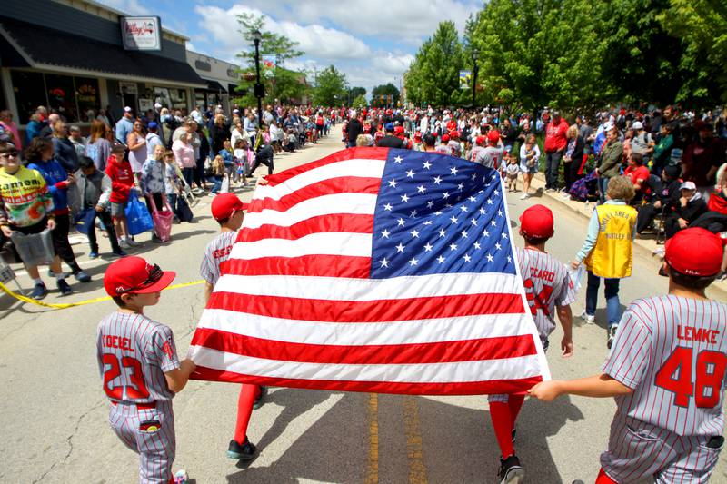 Huntley Little League members carry the Flag as part of the Huntley Memorial Day parade and observance Monday.